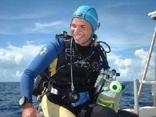 Eric O'Keefe in full scuba gear on a dive boat in Key West